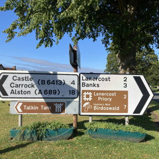 Signpost near Wall & Lakes Cottage for Lanercost Priory, Birdoswald, Talkin Tarn & local attractions