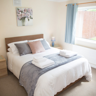 One of the two comfortable bedrooms with King-size beds at Wall & Lakes holiday cottage