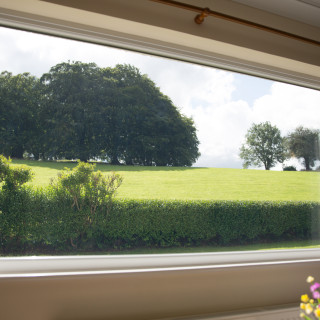Peaceful, countryside view from the living room at Wall and Lakes holiday cottage, Brampton