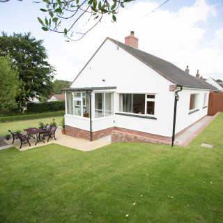 Large lawned garden wraps around Wall & Lakes holiday cottage, Brampton