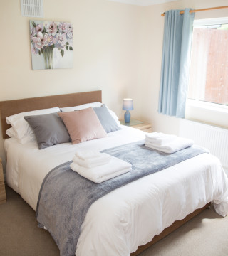 One of the two comfortable bedrooms with King-size beds at Wall & Lakes holiday cottage