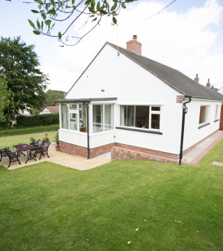 Large lawned garden wraps around Wall & Lakes holiday cottage, Brampton