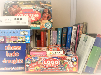 Inside the hall cupboard, books and games