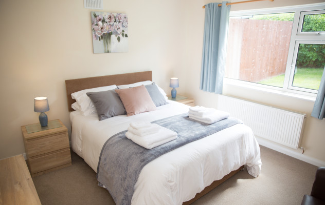 One of the two comfortable bedrooms with King-size beds at Wall & Lakes holiday cottage
