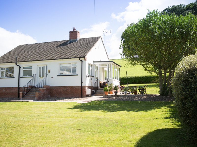 Front of Wall & Lakes holiday cottage, Brampton, Cumbria, large garden fields behind